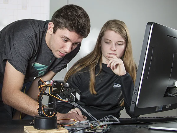 students working with a robot